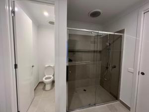 a bathroom with a shower and a toilet at Sun and Sea Holiday Home in Cowes