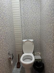 a bathroom with a white toilet in a stall at Apartment in Tashkent