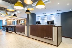 a bar in a restaurant with a counter and chairs at Premier Inn München City Schwabing in Munich