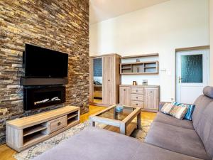 a living room with a couch and a fireplace at Westend Apartment in Budapest