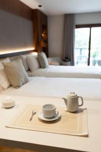 A bed or beds in a room at Five Hotel & Residences