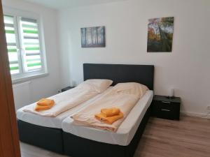 a bed in a room with two towels on it at Ferienwohnung August 24 in Gelenau