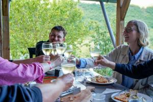 a group of people sitting around a table drinking wine at Ferma Albanik in Këlcyrë