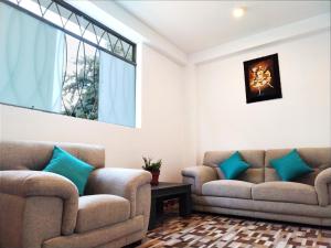 a living room with two couches and a window at Dreams Boutique Hotel Cusco in Cusco