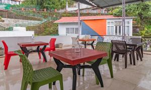 a group of tables and chairs on a patio at Itsy By Treebo - Peak View in Mussoorie