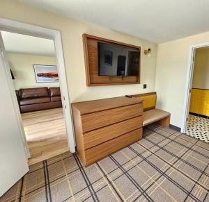 a living room with a television and a couch at The Hotel Laurel at Seneca in Watkins Glen