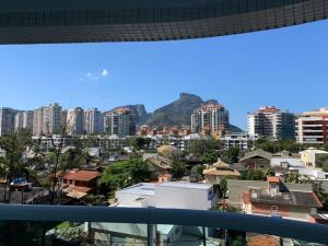 vistas a una ciudad con edificios y montañas en Wyndhan Barra Rio Janeiro en Río de Janeiro
