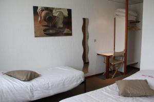 Postel nebo postele na pokoji v ubytování Hotel Halleux