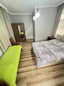 a bedroom with a large bed and a mirror at Guest House In Gonio in Gonio