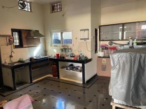 a kitchen with a sink and a counter in it at City Style Cottage in Surūrnagar