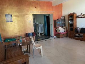 a living room with a table and chairs in it at City Style Cottage in Surūrnagar