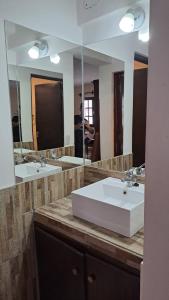 a bathroom with two sinks and a large mirror at LatorrePAS Dpto in Salta