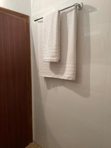 a bathroom with white towels hanging on a wall at GL House in Asprovalta +11 photos