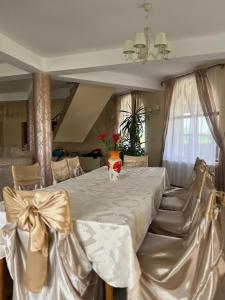 a dining room with a large white table with chairs at Casa Mardar in Oradea