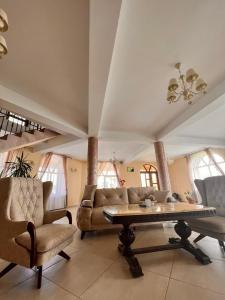 a living room with a couch and a table and chairs at Casa Mardar in Oradea