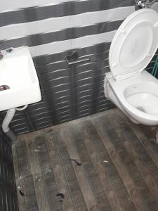 a bathroom with a toilet and a sink at Ktm cottage in Kotagiri