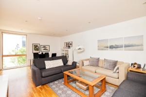 a living room with a couch and a table at The Jasper Walk Escape - Charming 2BDR Flat with Balcony in London