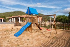 a playground with a slide and a swing set at Villa Evie in San Antonio