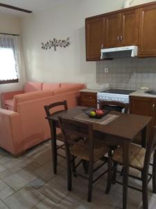 una cucina e un soggiorno con tavolo e divano di Vromolithos apartments #4 a Vromolithos