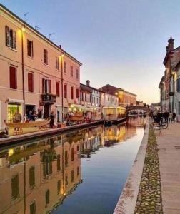 a view of a canal in a city with buildings at Locanda della Pescheria in Comacchio