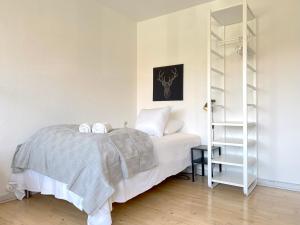 a bedroom with a bed and a book shelf at Studio Apartment In Glostrup, Hovedvejen 70, 3 in Glostrup