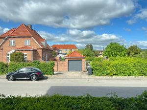 a black car parked in front of a house at Studio Apartment In Glostrup, Hovedvejen 70, 3 in Glostrup