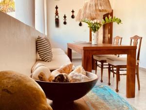 a living room with a table and a bowl of food at Pucci House Watamu in Watamu
