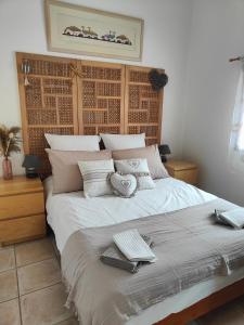 a bedroom with a large bed with two keyboards on it at Domaine Bellavigne Gites et SPA in Forcalquier