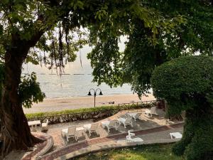a group of chairs and tables and a beach at Sky Beach Pattaya in North Pattaya