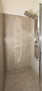 a bathroom with a stainless steel refrigerator in a room at Tedimo Supra in Ragusa