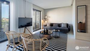 a living room with a couch and a table and chairs at Apartment Micaela in Vale do Lobo
