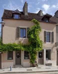 une maison avec du lierre sur son côté dans l'établissement Vign 'Appart, à Nuits-Saint-Georges