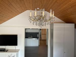 a chandelier hanging from a ceiling in a living room at Apartment Auszeit in Bad Neustadt an der Saale