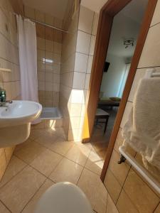 a bathroom with a toilet and a sink and a shower at U Gacka in Władysławowo +31 photos