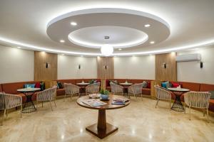 a restaurant with tables and chairs in a room at Martı Myra - Ultra All Inclusive in Tekirova