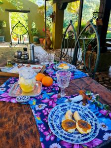 a table with plates of food and oranges on it at Hotel Rural Casa Alfayales-Only Adults in Poyales del Hoyo
