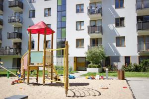 um parque infantil em frente a um edifício de apartamentos em MP Rent- 48m, klimatyzacja, ogródek, parking, Jana Kazimierza, TravellerRevAwards2024 em Varsóvia