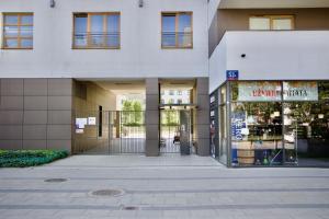 an entrance to a building with a store at MP Rent- 48m, klimatyzacja, ogródek, parking, Jana Kazimierza, TravellerRevAwards2024 in Warsaw