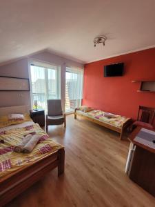 a hotel room with two beds and a tv at U Gacka in Władysławowo