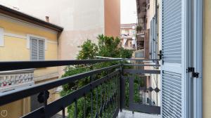 an apartment balcony with a railing and plants at Liberty Home in Sesto San Giovanni