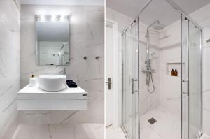 a white bathroom with a shower and a sink at Seaside Nestie by BluPine in Athens