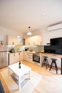 a kitchen with a white table in the middle of it at Feelin' Good Apartment in Ioannina