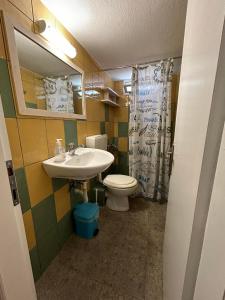 a bathroom with a sink and a toilet at Orange Tree Garden in Pefkochori