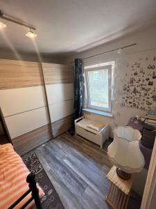 a small bedroom with a bed and a window at Gästehaus Linden - Zweibettzimmer in Linden