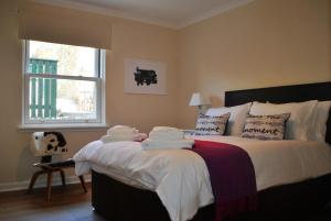 a bedroom with a bed with towels on it at James Haven- coastal townhouse East Neuk in Anstruther