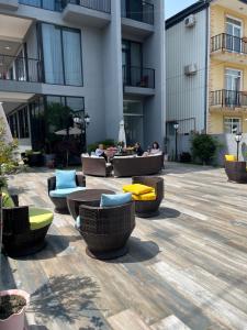 a courtyard with couches and chairs in a building at Cozy Rooms in K'obulet'i