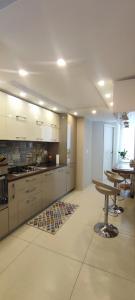 a large kitchen with white cabinets and a table at Astrea in Naples