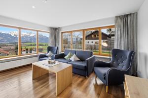 a living room with a couch and two chairs and a table at Berghaus Mucha - Ferienwohnungen - Naturpark Partner in Bolsterlang