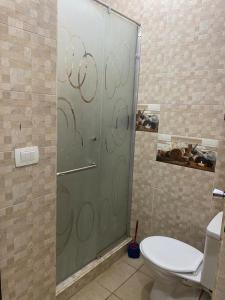 a glass shower door in a bathroom with a toilet at الساحل الشمالي. قريه جراند هيلز الكيلو60 in Dawwār ‘Abd Allāh