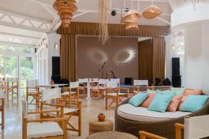 a living room with a couch and tables and chairs at Martı Myra - Ultra All Inclusive in Tekirova